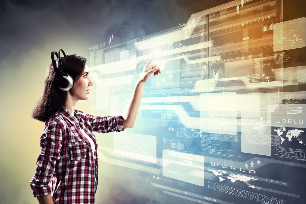 Image of young woman with headphones touching virtual screen