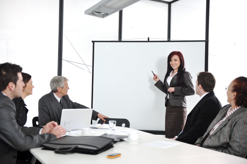 Business meeting - group of people in office at presentation